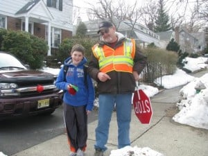 Sixth grader, Billy Gault, poses with school crossing guard, magician and friend Jim Schroeder. In addition to helping Billy get across the street safely, Jim has been a magic mentor to the 12-year-old.