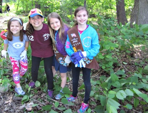 Emma Kirby, Anna Collins, Tessa Bichalski, and Sophie Hacker from Brownies Troop 20228 cleared ground to plant behind their school  
