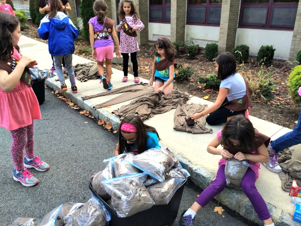 D'Alessandro puts together his packs with donated supplies and volunteer help, like these Girls Scouts.