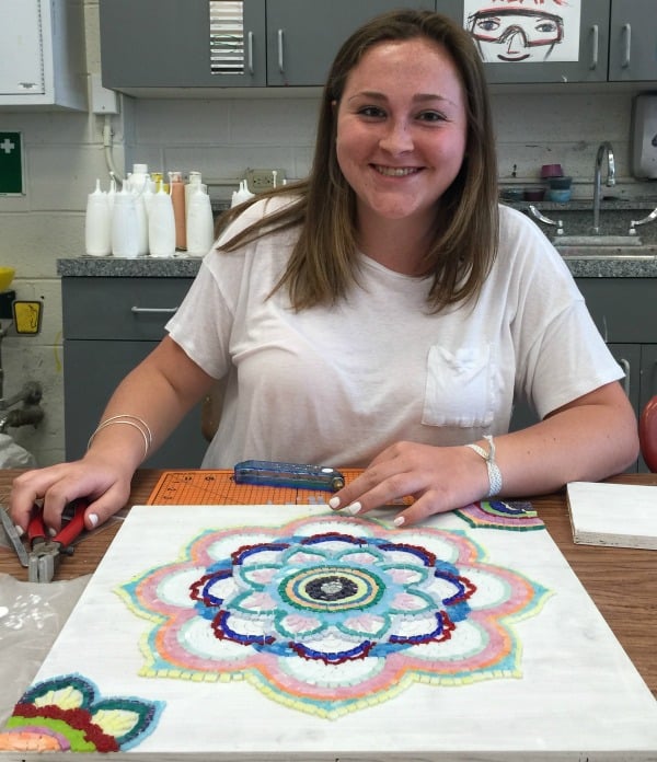 Mikayla Kiefer finishes her mosaic for the festival.