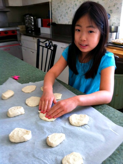 Stella Kim helps make the bread for her first communion. The church helped Stella celebrate her first communion on Sunday, May 3.