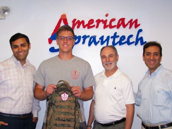Sgt. Brett D’Alessandro, Backpacks for Life, flanked by Manav Lalwani, Bob Daria and Allen Lalwani, all of American Spraytech.