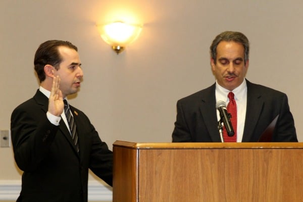 Township Attorney Michael Gannaio (right) administers the oath of office to Alex Roman.