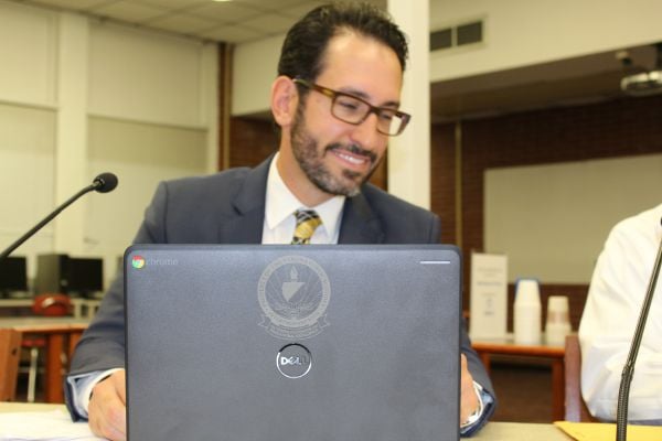 Superintendent Rui Dionisio with the new Verona-branded Chromebook.