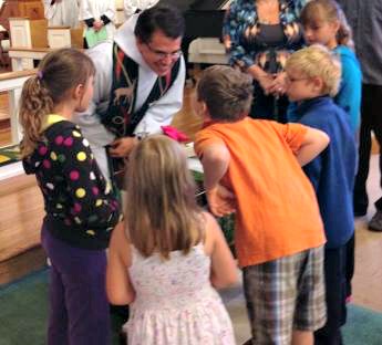 On the third Sunday of the month, the children of Holy Spirit assist Father Jerry as he sets the altar for Holy Communion and teaches them about the sacrament. 