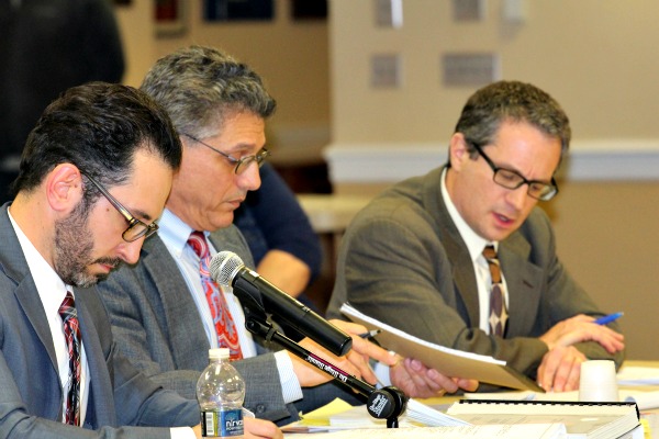 Verona Public Schools Superintendent Rui Dionisio (left) faced lengthy questioning from Robert Simon, a lawyer representing the field project's opponents.