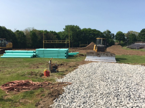 The sewer pipes were stockpiled on the upper field last week in preparation for their installation along Sampson Drive.