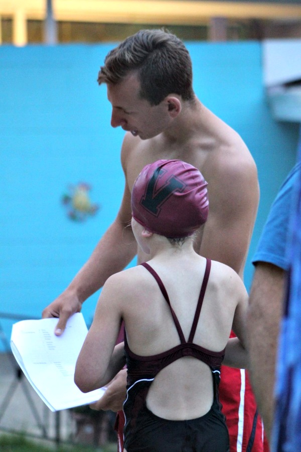 Anthony Giuliano helps out fellow swimmer Kelly Barrow. 