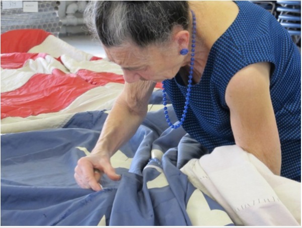 Franca Tanelli repairing the 9/11 flag in 2011.