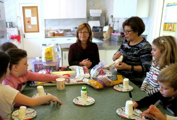 Pastor Lynn Rubier-Capron and Felicia Burgos help with the making of marshmallow snowmen.