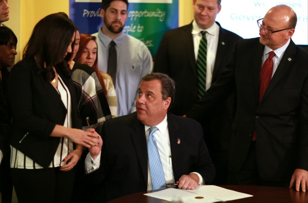 Governor Chris Christie hands former Integrity House Consumer Vanessa Vitolo a pen after signing Executive Order No. 219 declaring the state's opioid epidemic a public health crisis while at Integrity House in Newark, N.J. on Tuesday, Jan. 17, 2017. (Governor's Office/Tim Larsen)